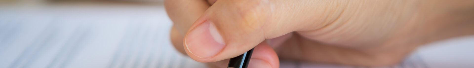Close up of hand completing an employment application form